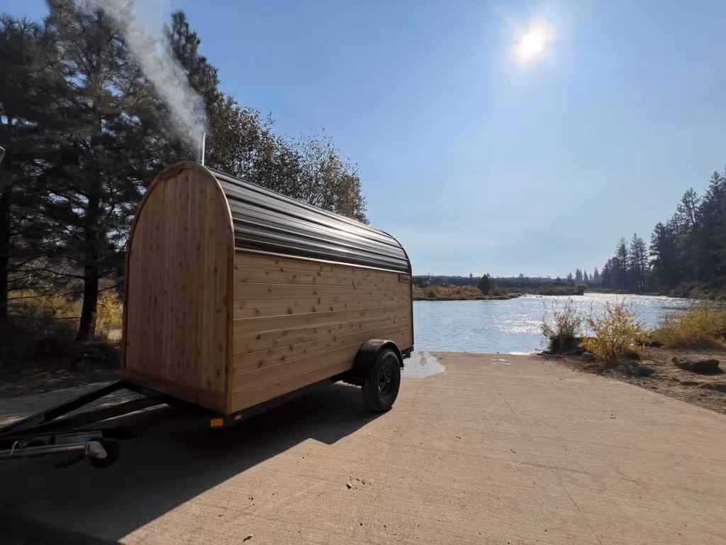 A small wooden trailer with smoke coming out of it.