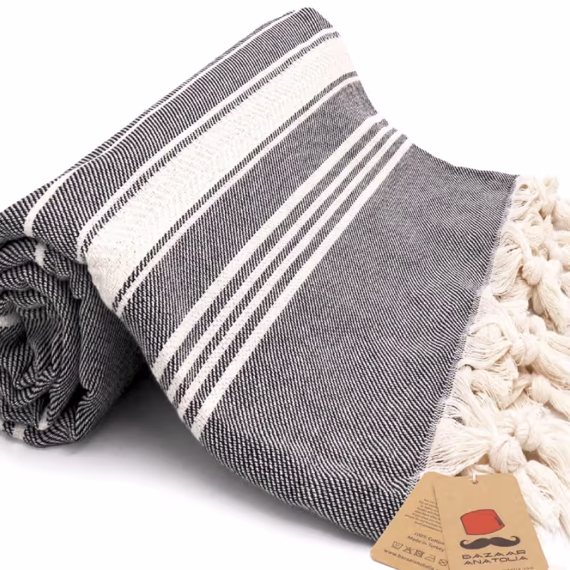 Two folded spa towels with striped gray and white patterns.