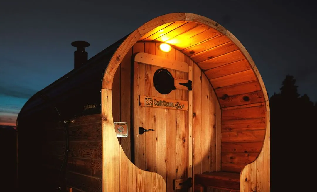 SaltSaun mobile sauna set up in nature with a view of the sunset