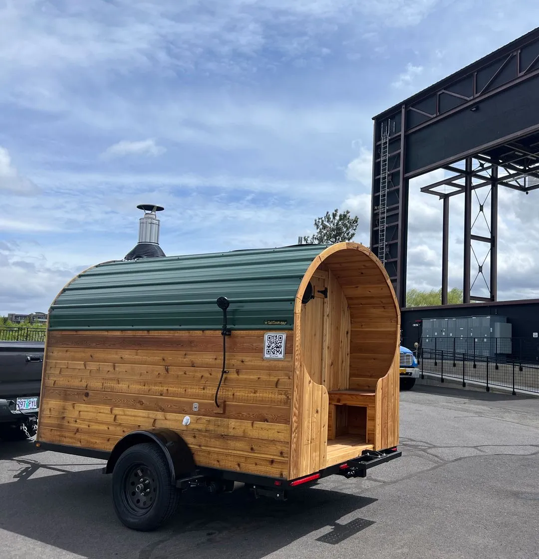 A small wooden trailer with a green roof.