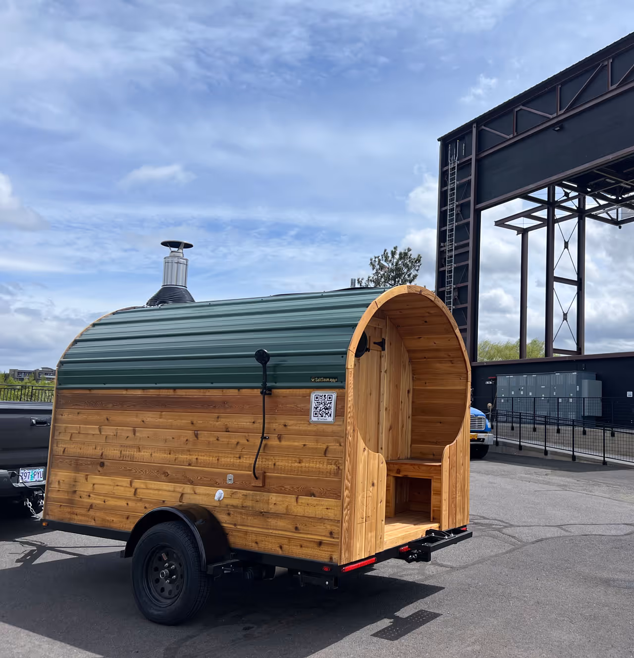 A small wooden trailer with a green roof.