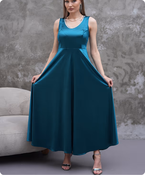 Model in emerald green maxi gown Liona with wide straps and flared hem, front pose – Farika collection