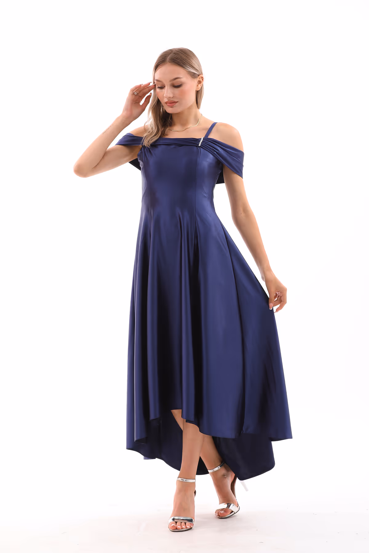 Front view of the Valeria gown in navy satin, featuring off-shoulder draped sleeves and a flared high-low hem.