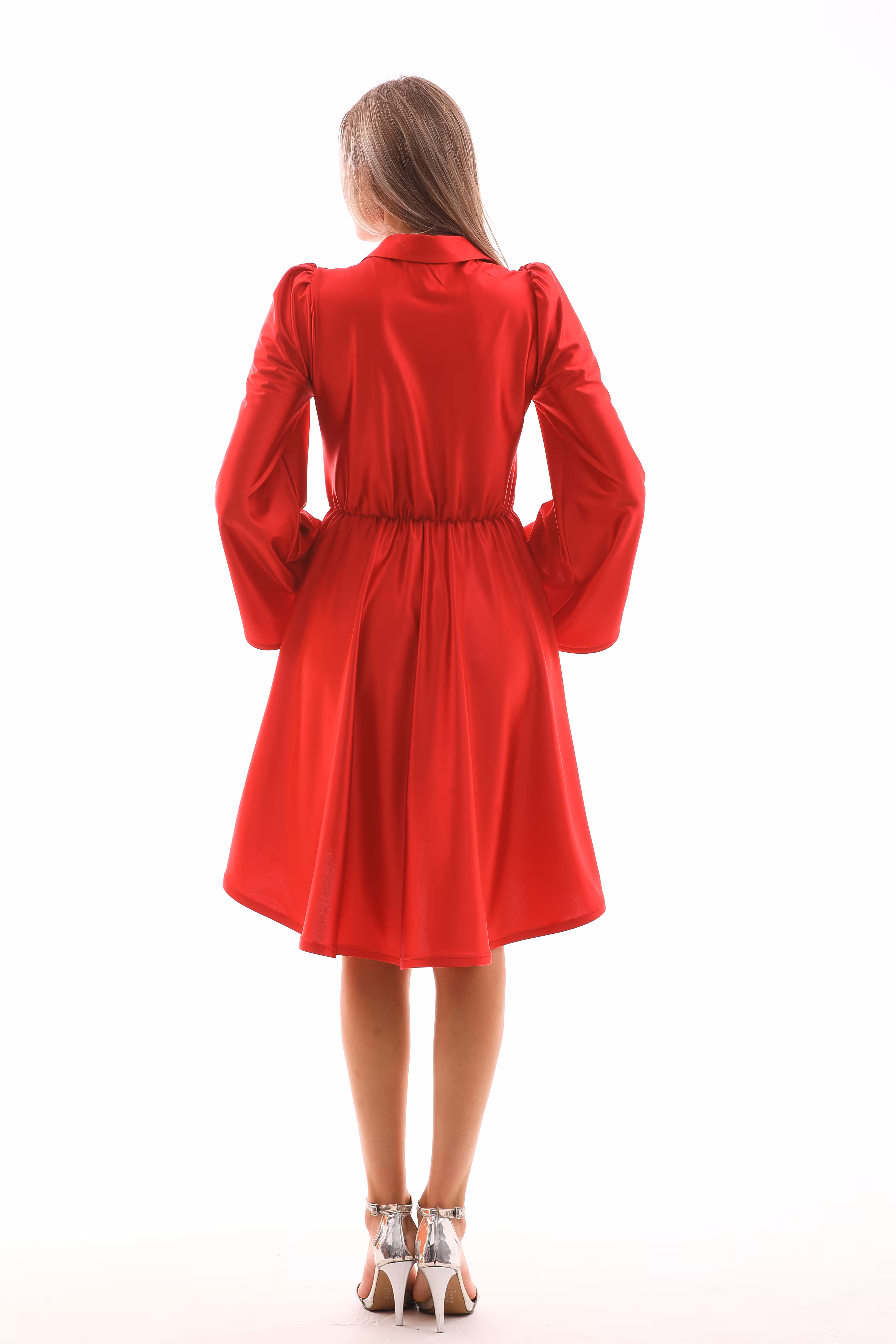 Back view of model wearing Arlena red satin mini dress with flared sleeves and gathered waist.