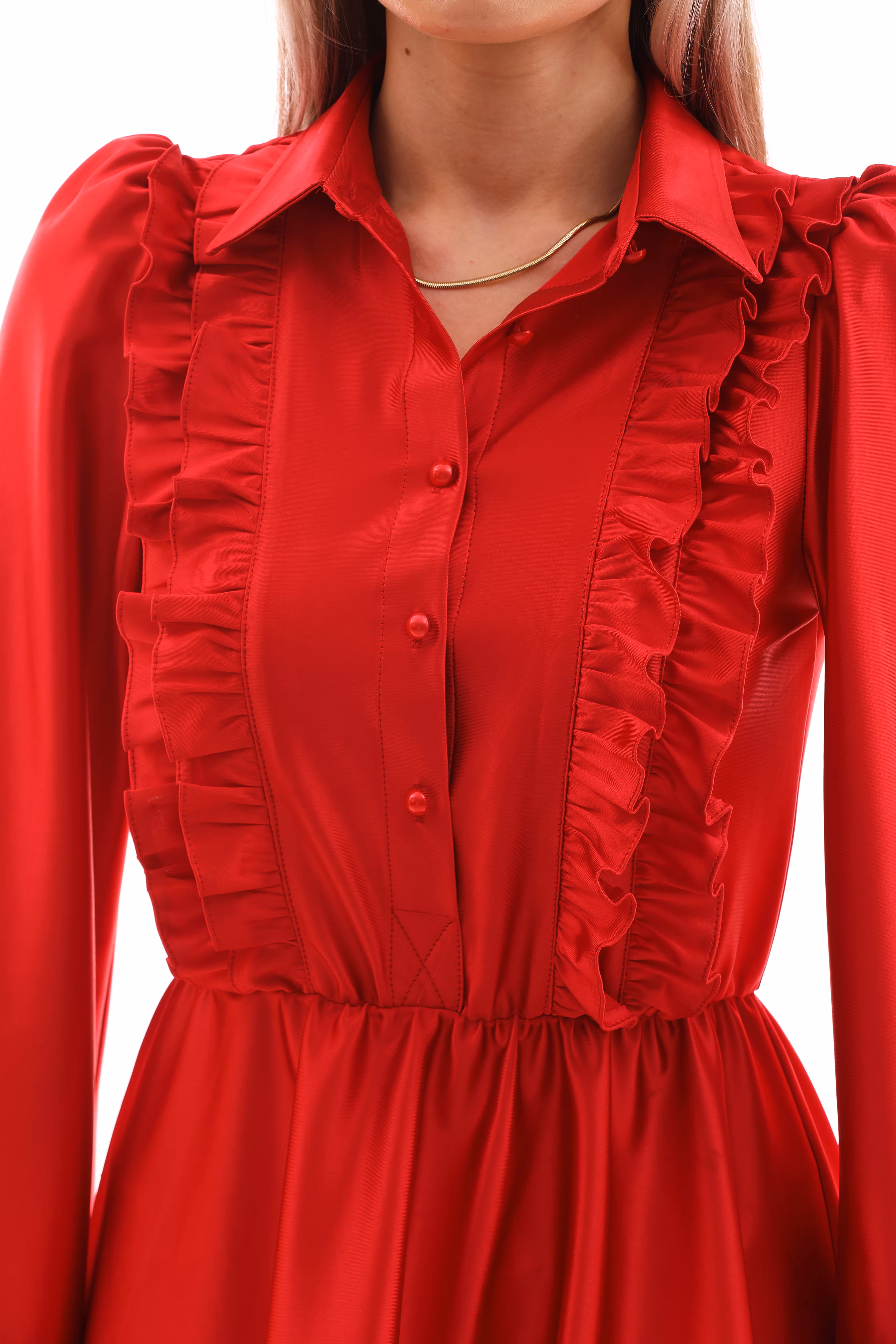 Close-up of ruffled bodice and buttoned front detail of Arlena red satin mini dress.