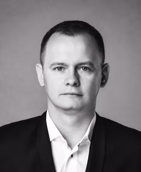 A B&W portrait of a smiling man Przemysław Lelonek