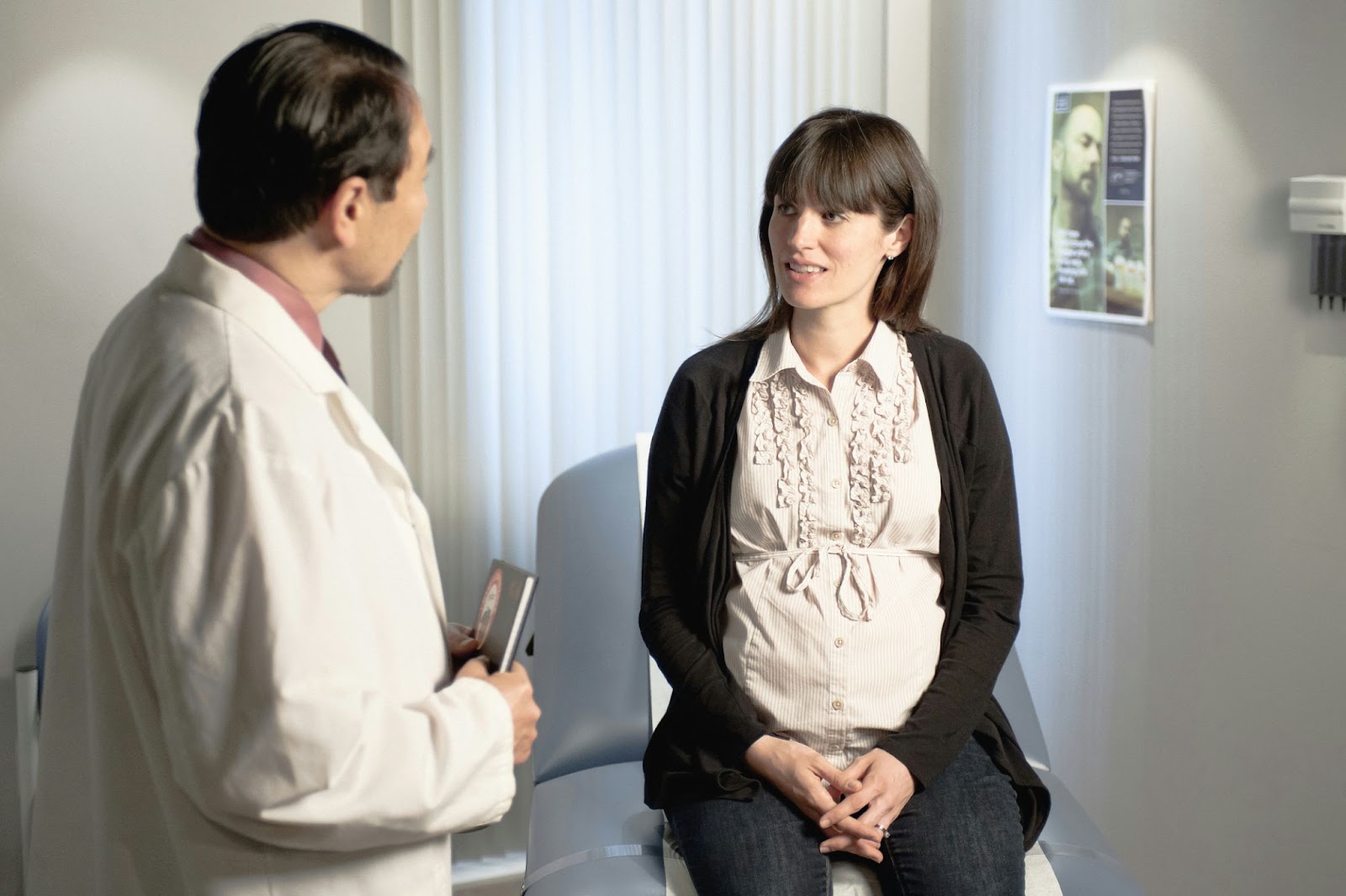 Doctor with patient while AI transcribes conversation