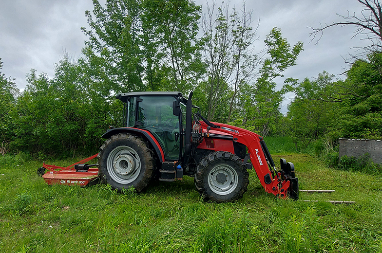 Tractor working with a front end attachment