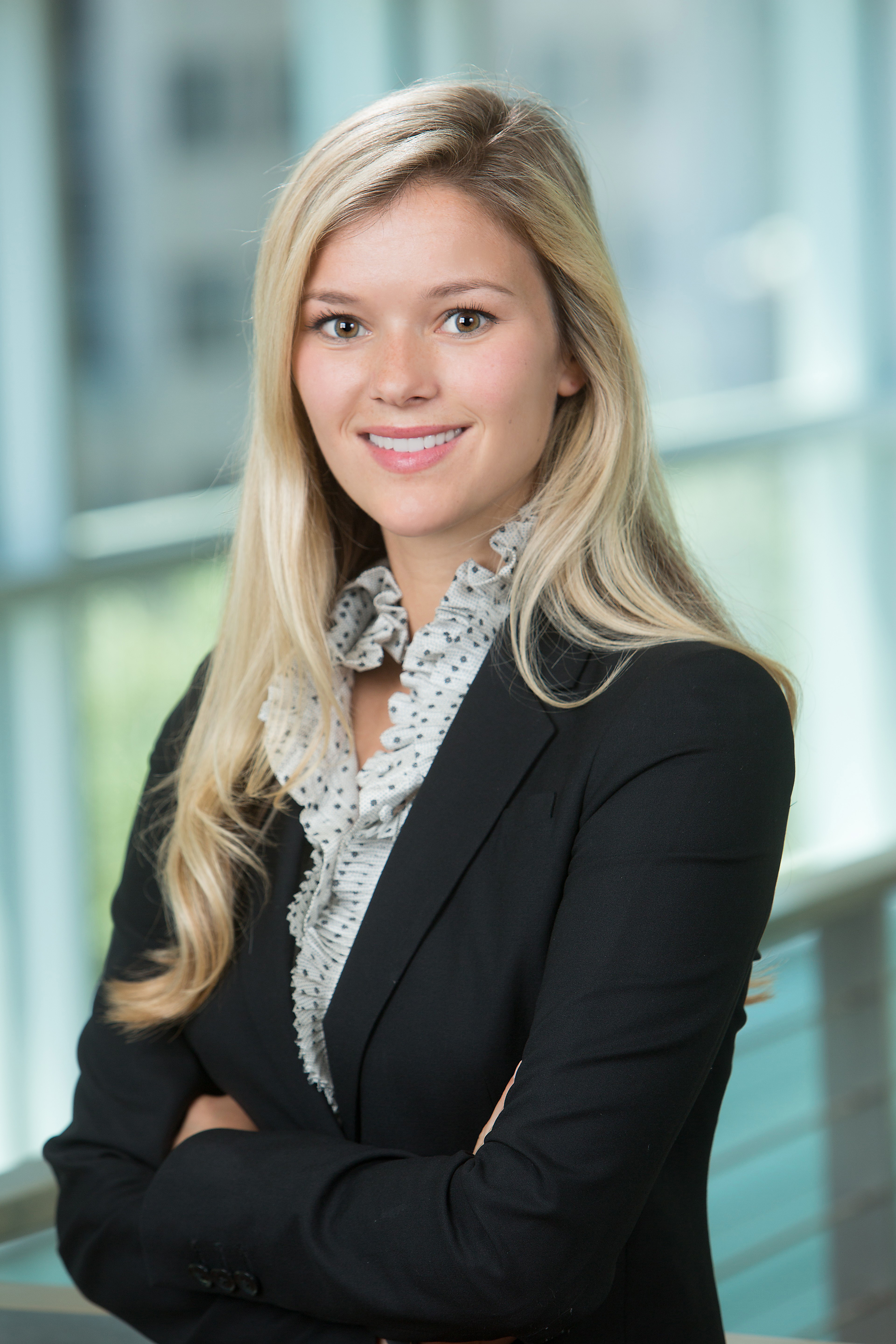 A young blonde haired woman smiling at the camera