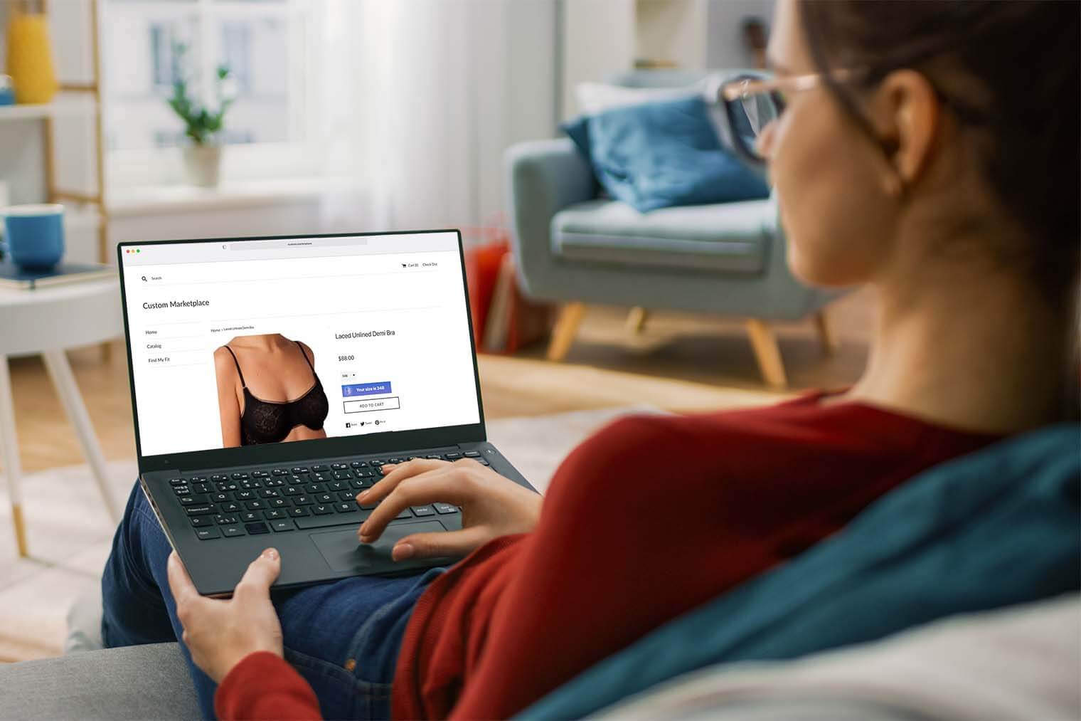 An over the shoulder shot of a woman shopping online on a laptop