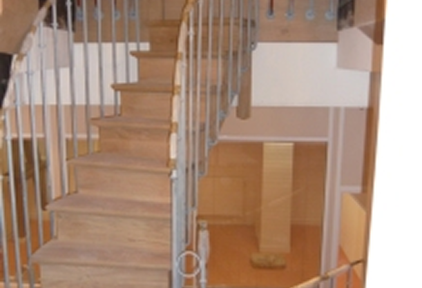 Escalier en bois avec rampe métallique dans un intérieur résidentiel.