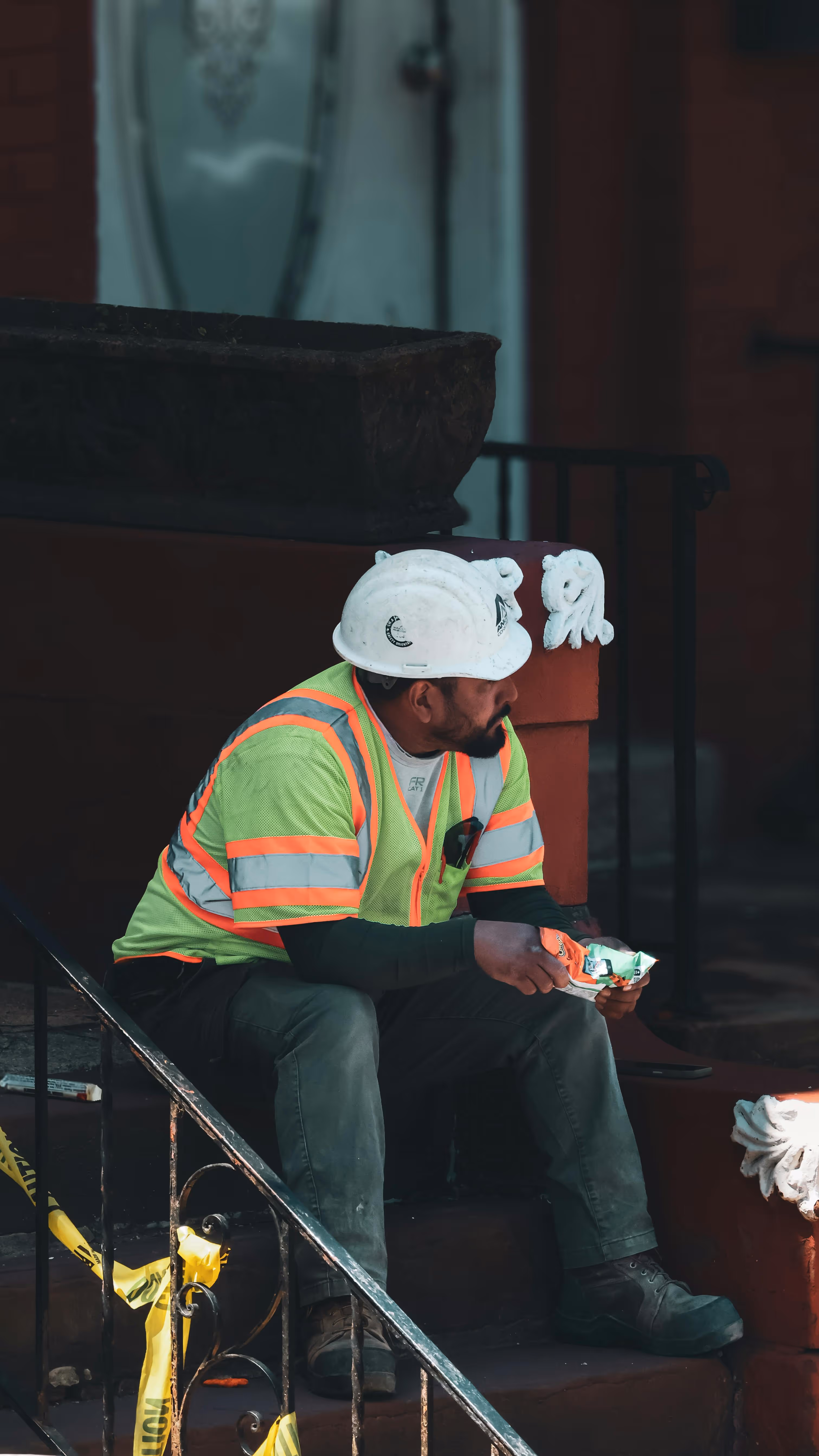 A construction worker taking a break on site after he has been delayed on a project
