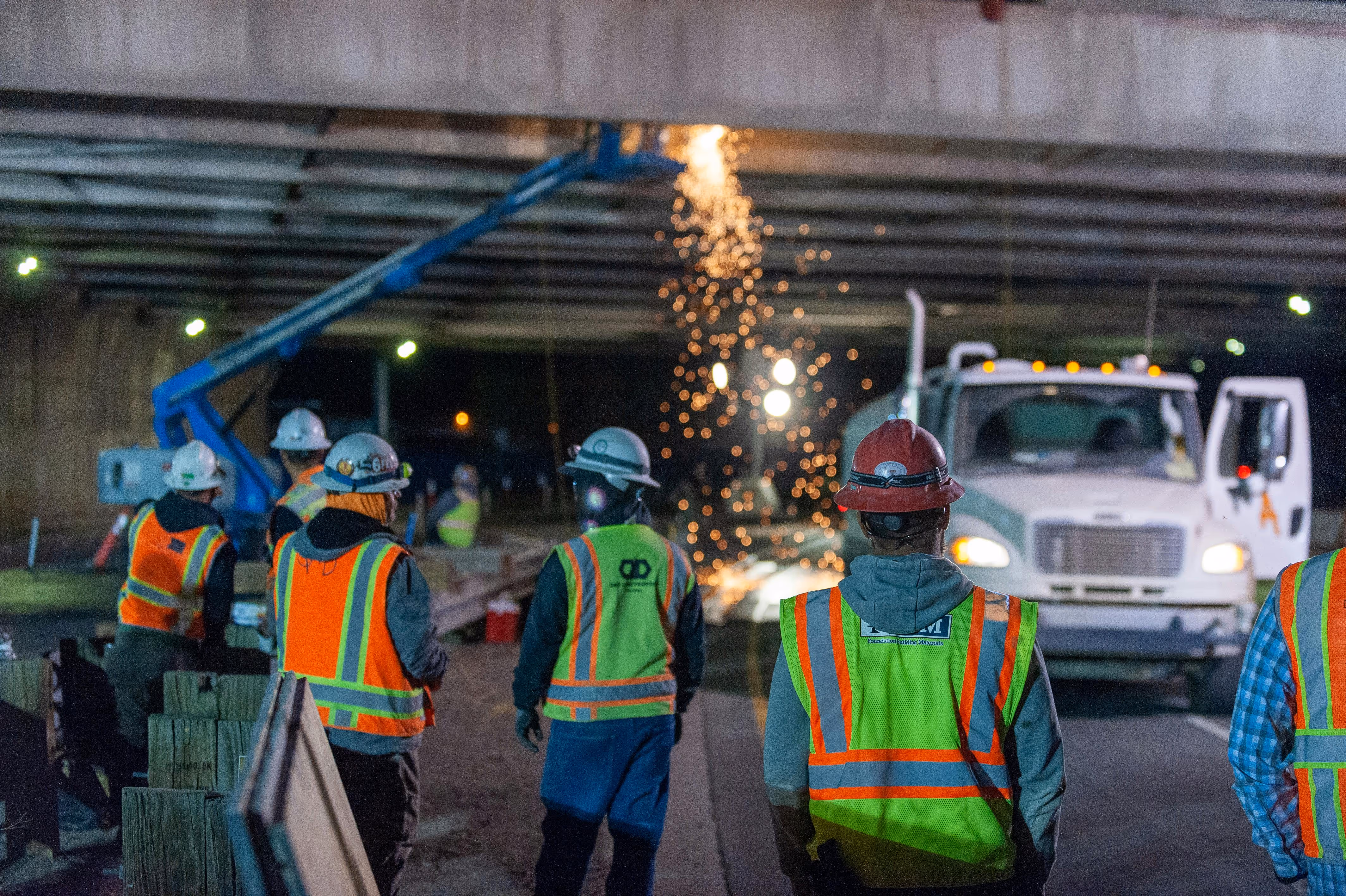 Construction crew working on a road project at night