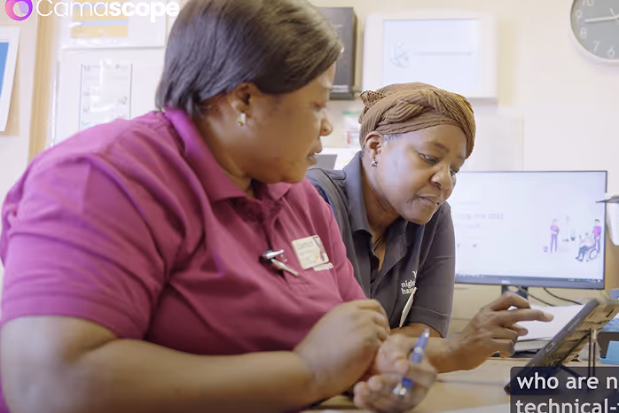 Two women looking at a phone