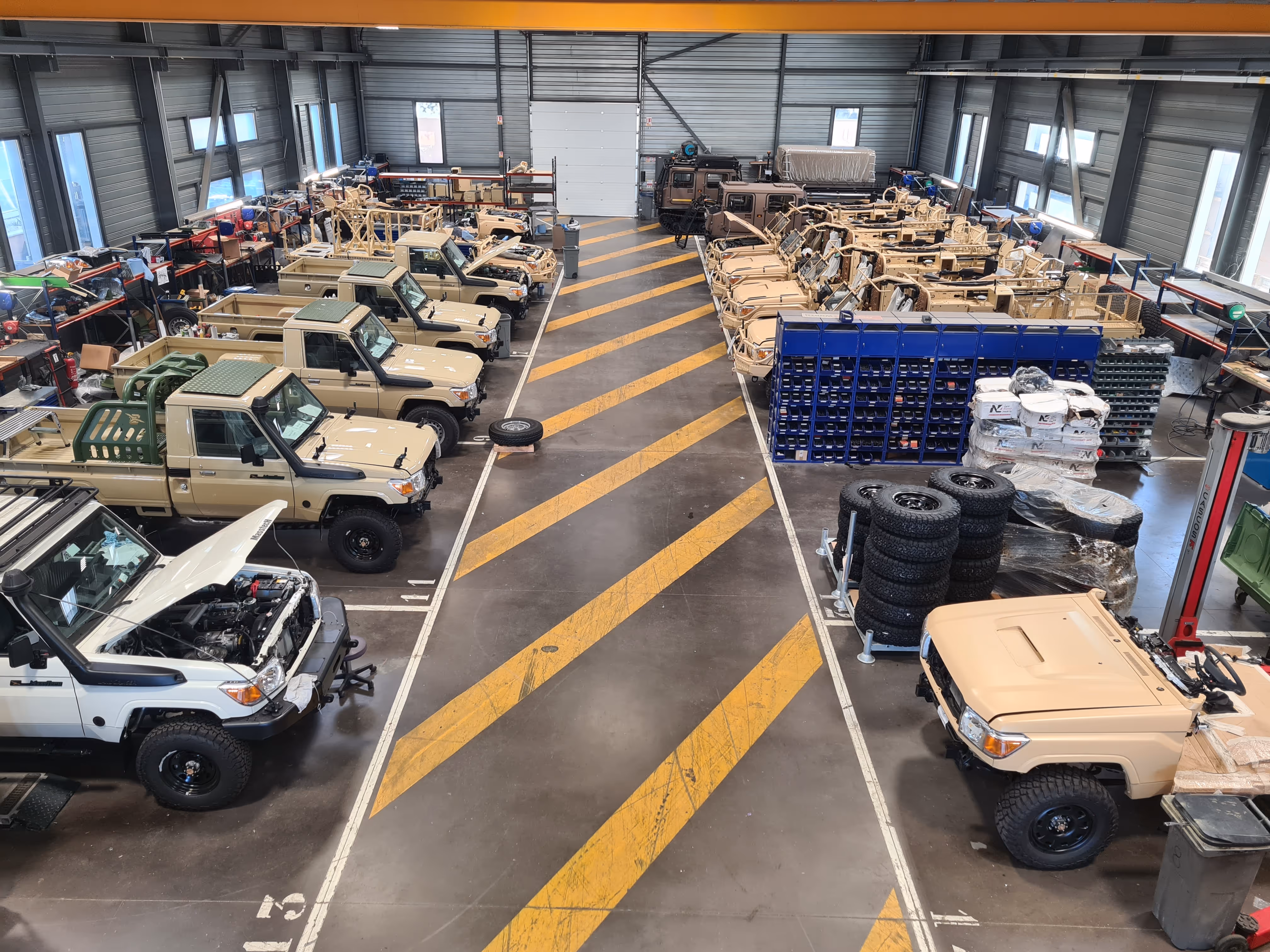 Technamm workshop with military vehicles in preparation.