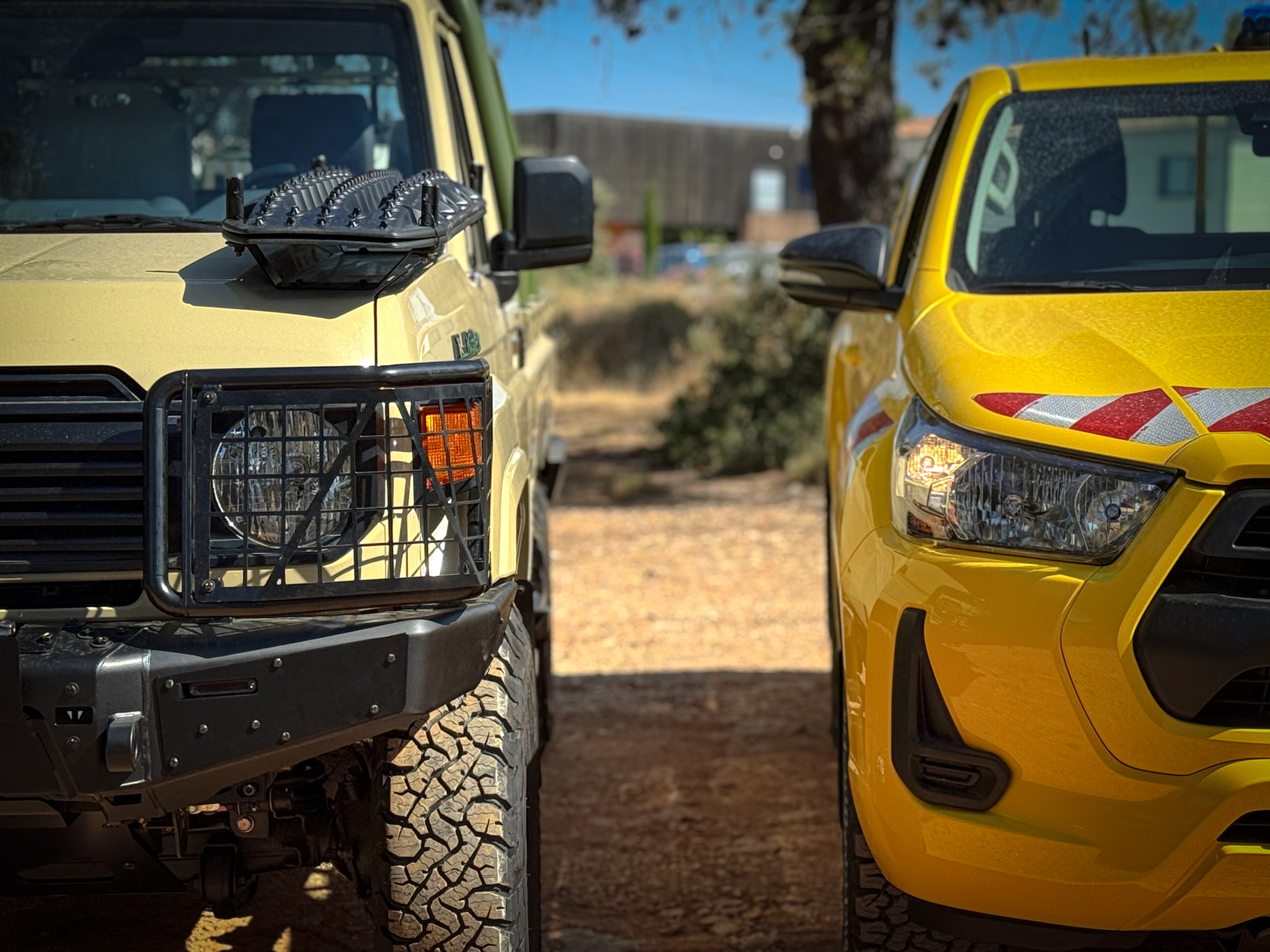 Close-up of two Technamm civil and special vehicles on outdoor display.