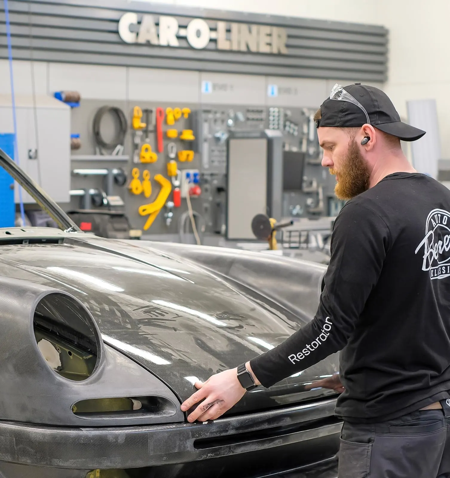 Hendrik Tasa of Benefit fitting a front bumper on Porsche 911 restomod by Kalmar Automotive