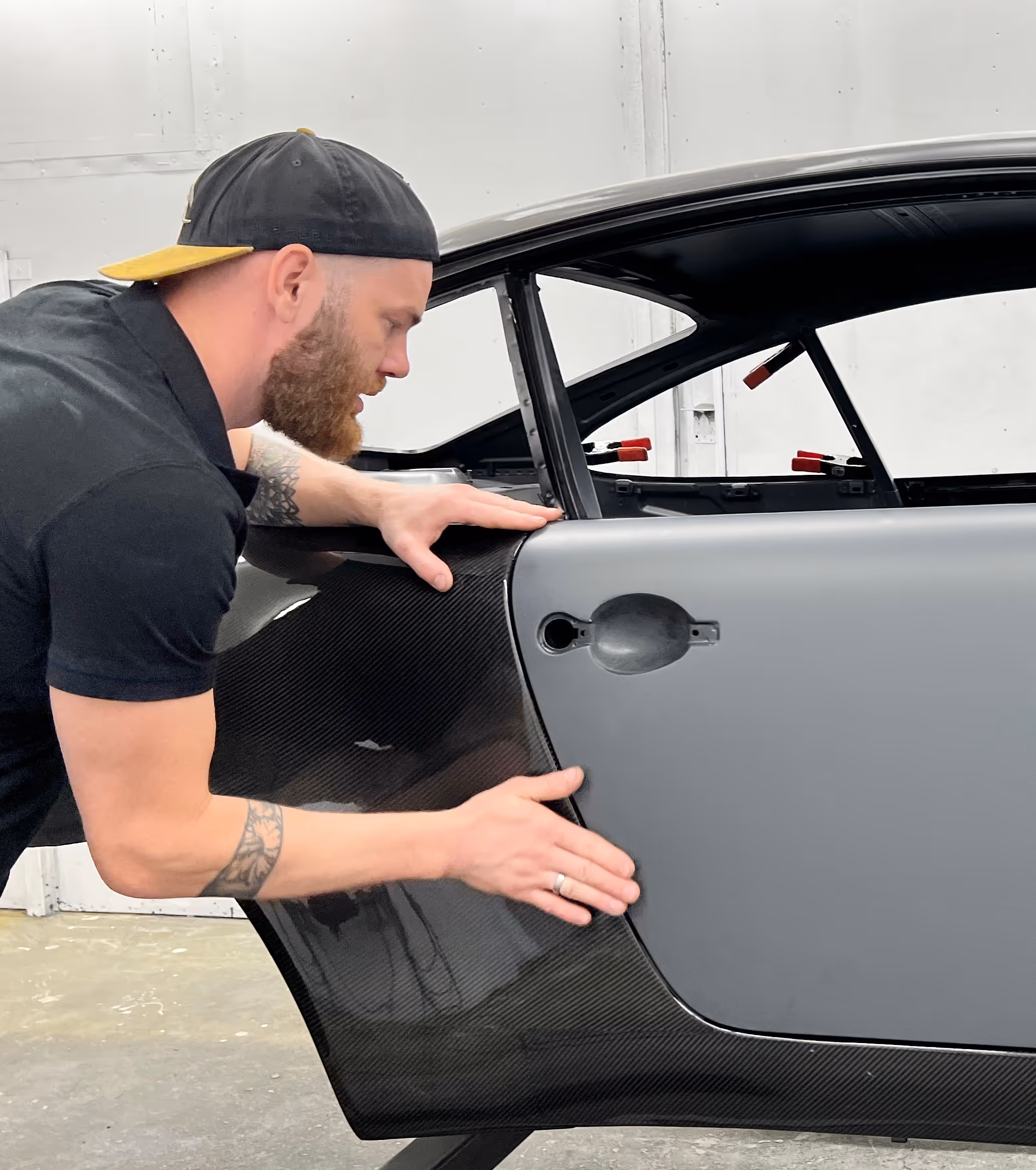 Hendrik Tasa fitting a door on a grey Porsche