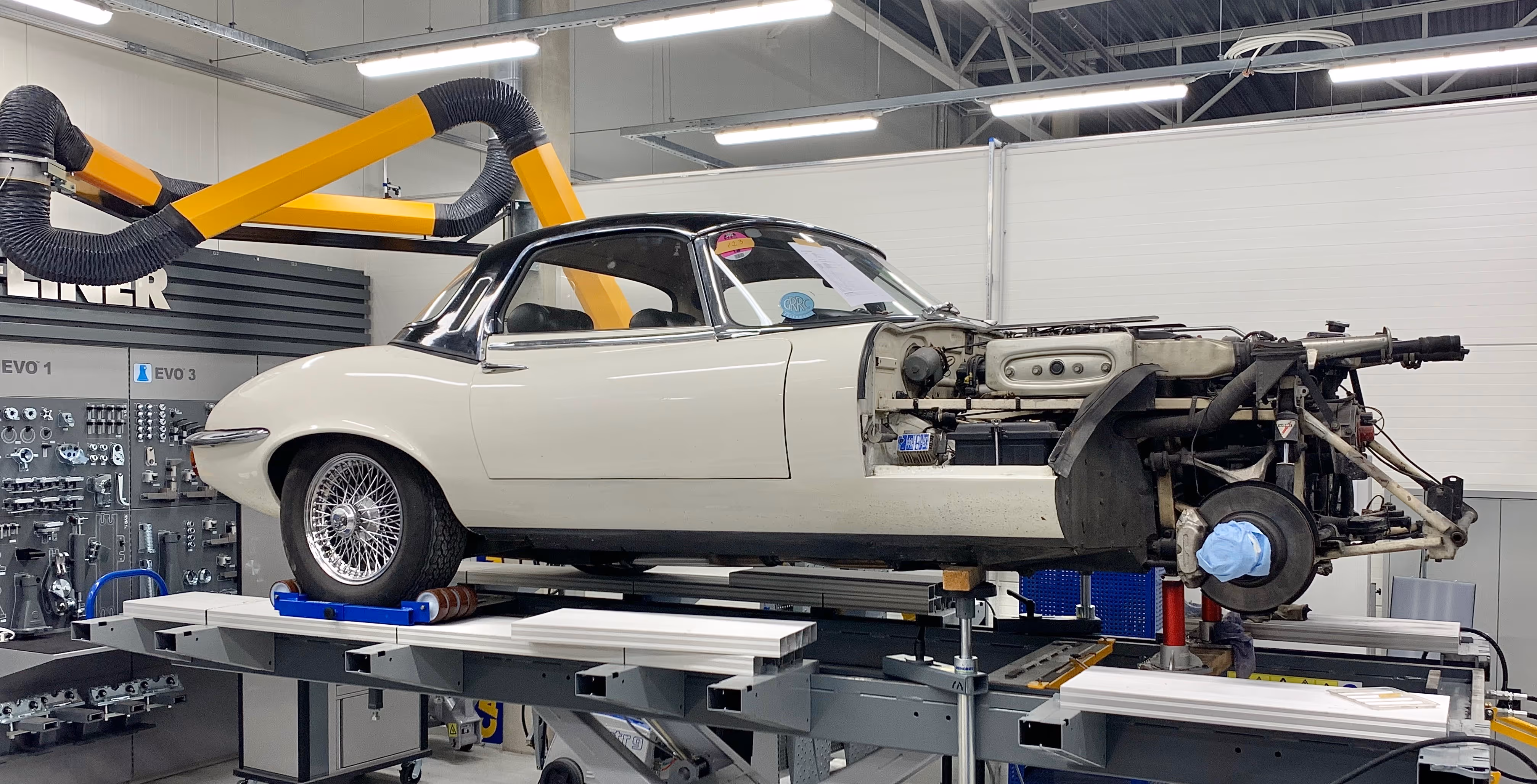White Jaguar E-type being restored in a workshop