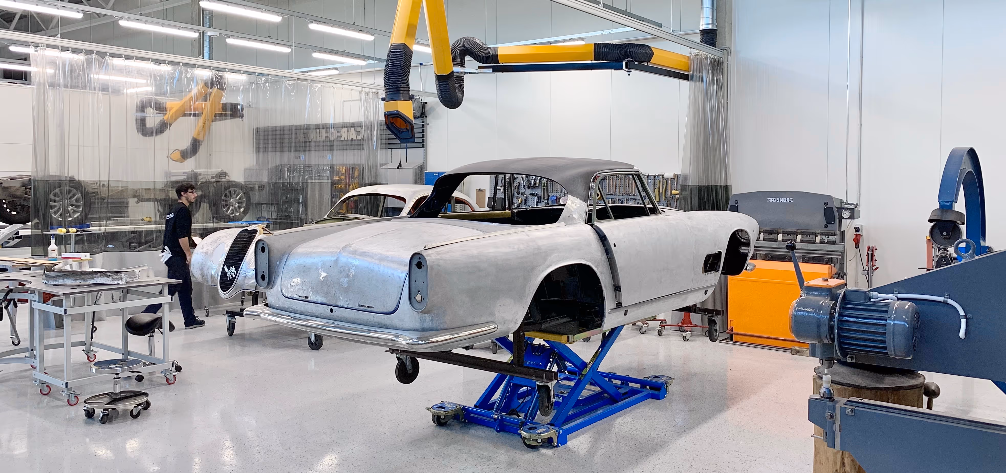 Alfa-Romeo and Maserati being restored in a workshop