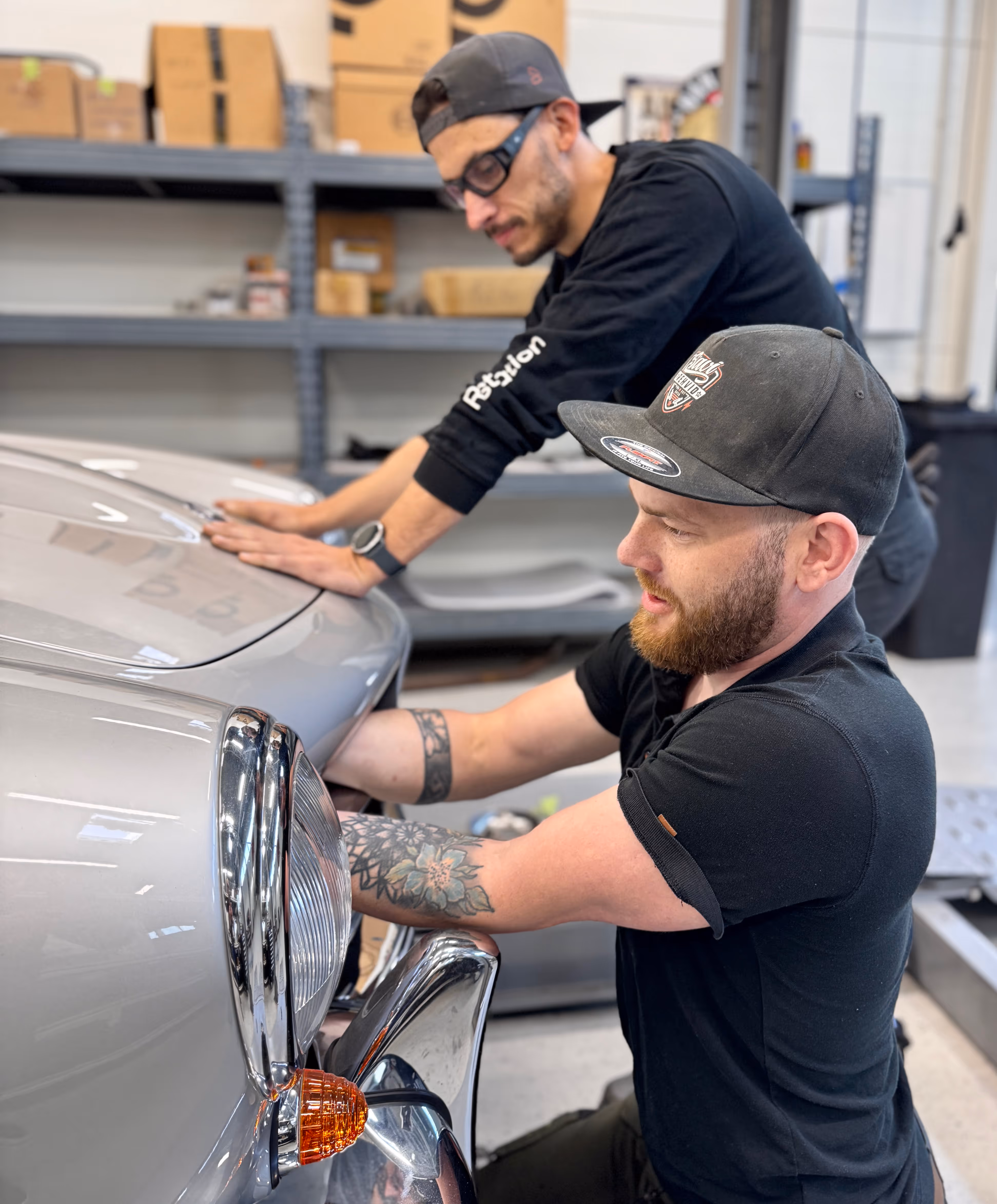 Two mechanics working a Mercedes-Benz 190SL