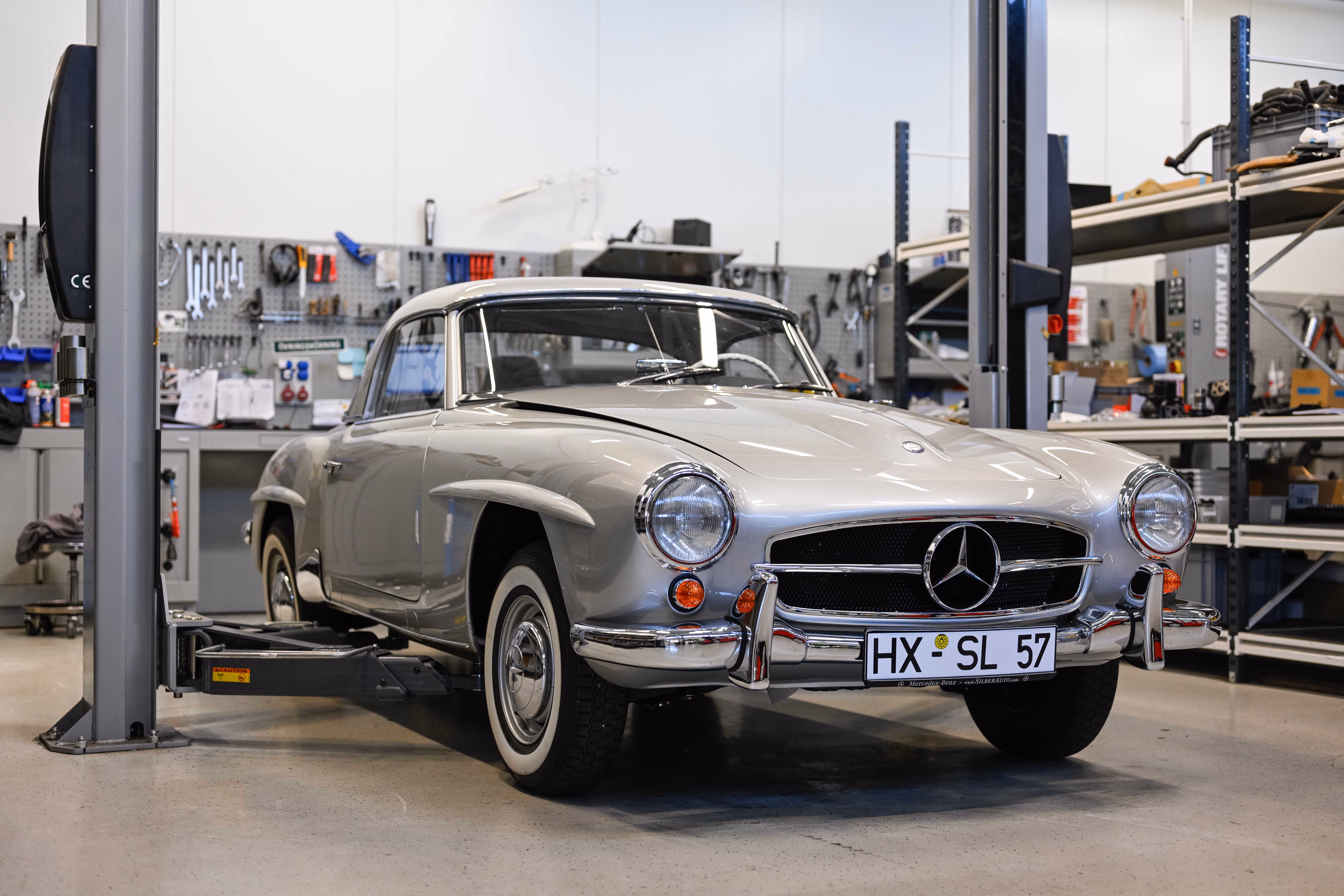 Mercedes-Benz 190SL on a car lift in a workshop