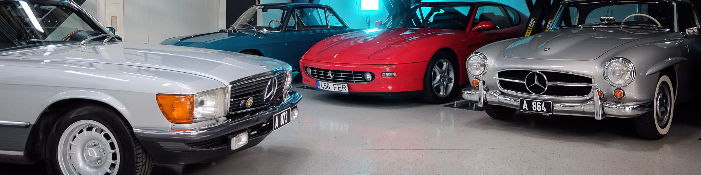 Inside of Benefit AutoKlassika workshop with Mercedes-Benz 190SL, Mercedes-Benz 500SL, Ferrari and Lancia Fulvia