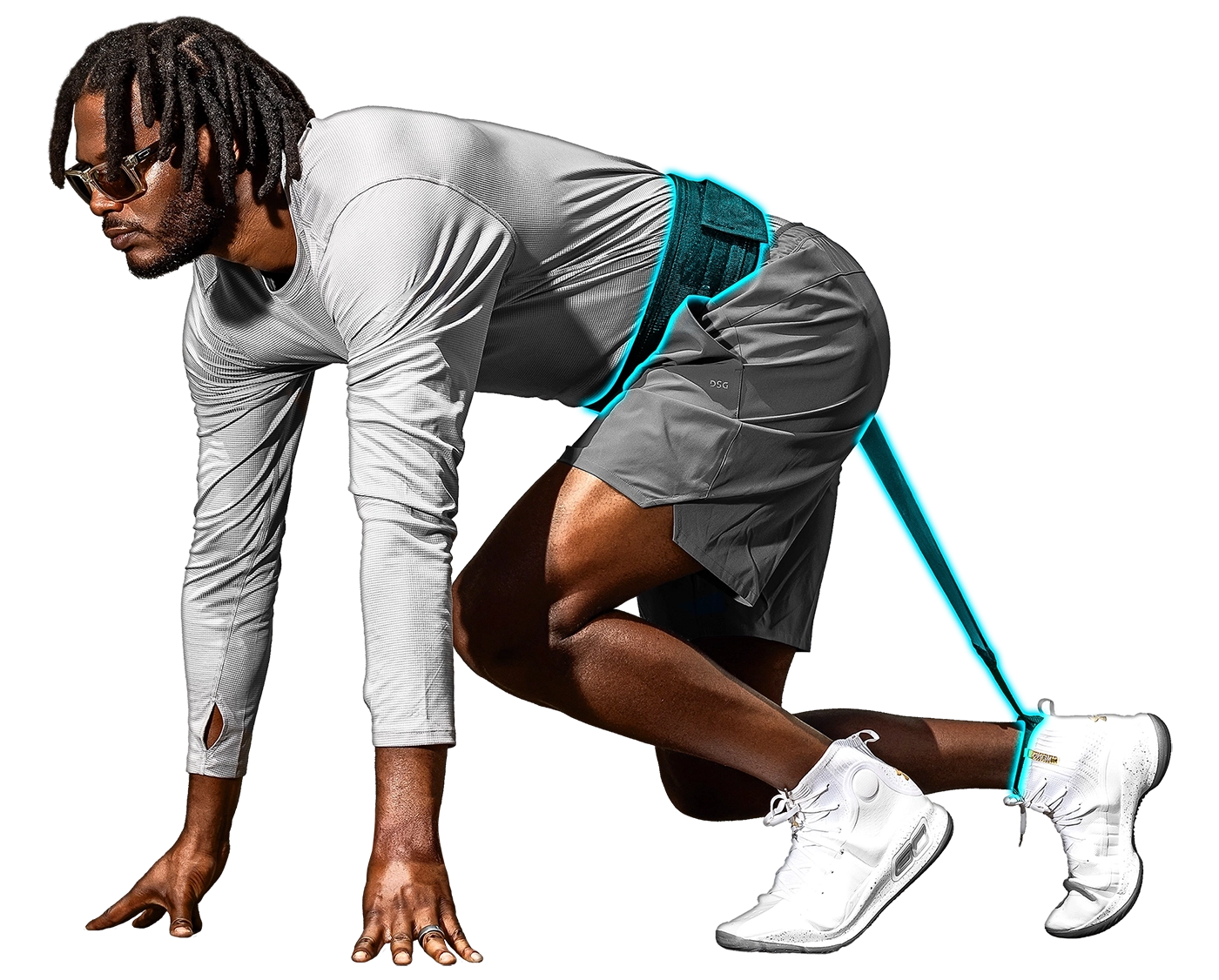 Athlete in grey shirt, shorts, and white shoes in a runner's start position wearing a Shanban.