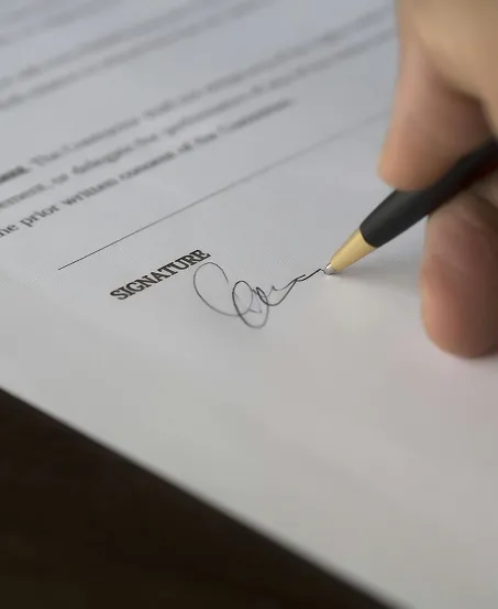 Closeup of a signature being written on a contract