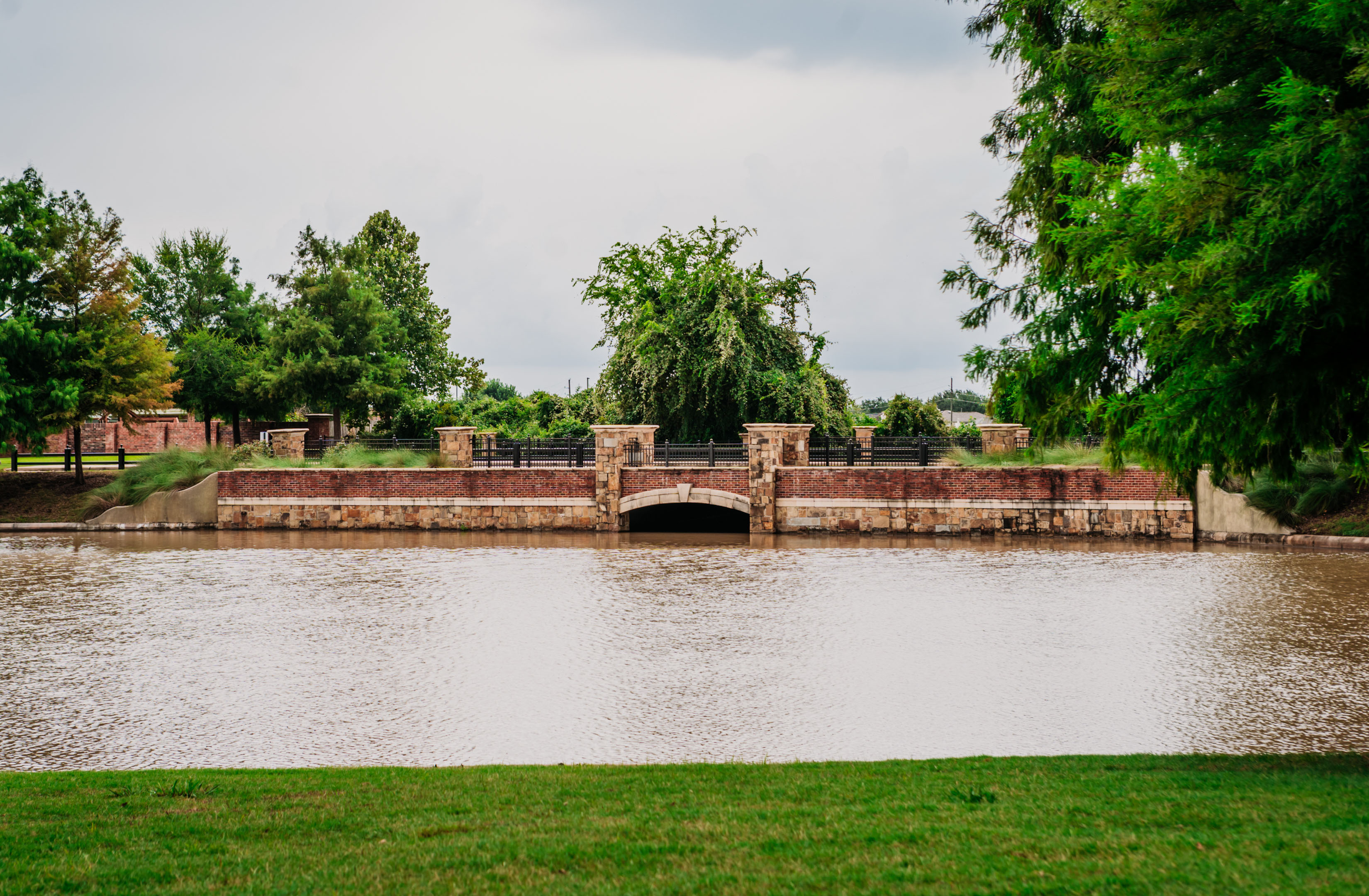 Elegant bridge wall Brick Wall Cladding, Stone Veneer on Piers and Ornamental Iron Rails