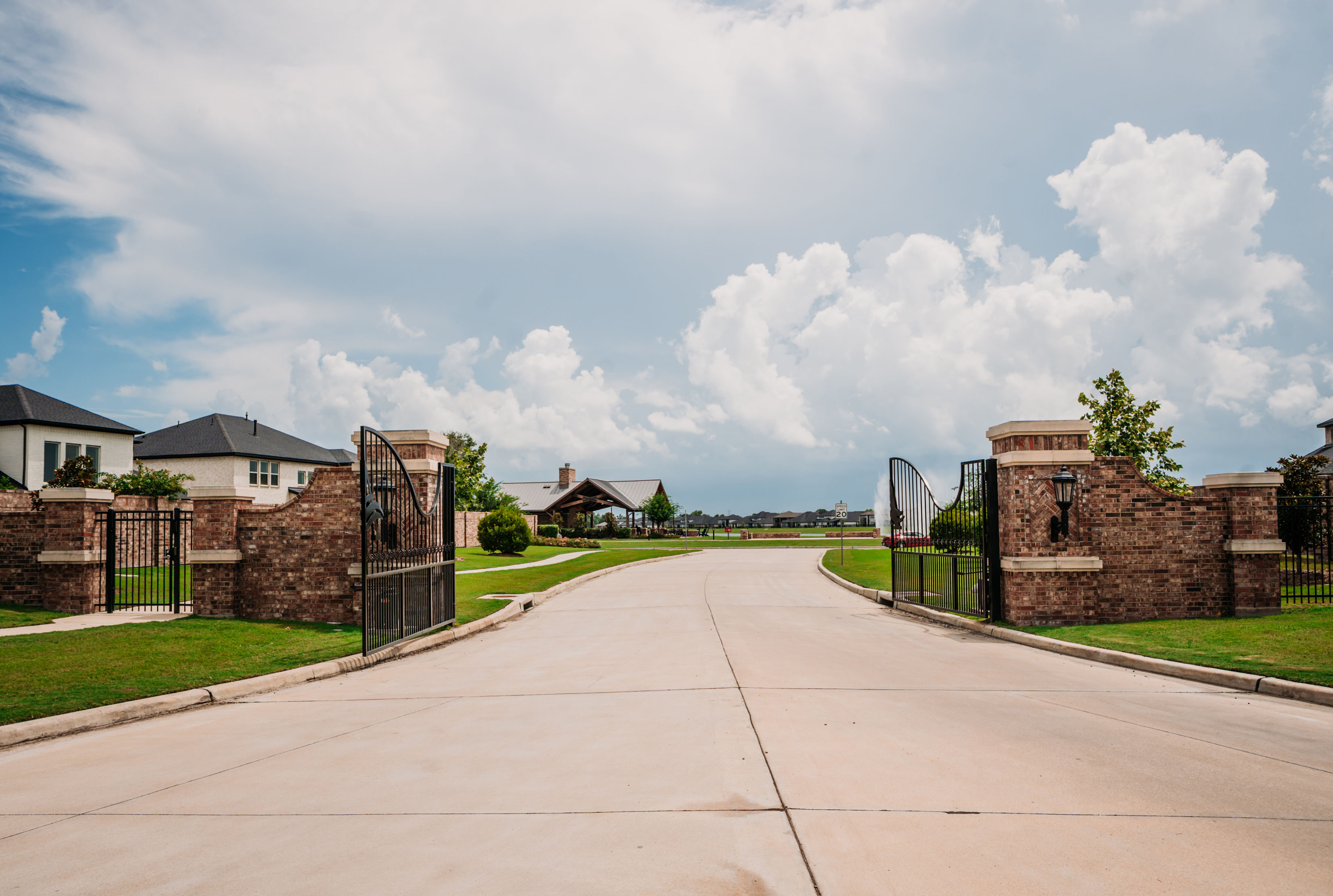 Iron Vehicular Entry Gate with Brick Masonry Columns offers Security and Gated Exclusivity