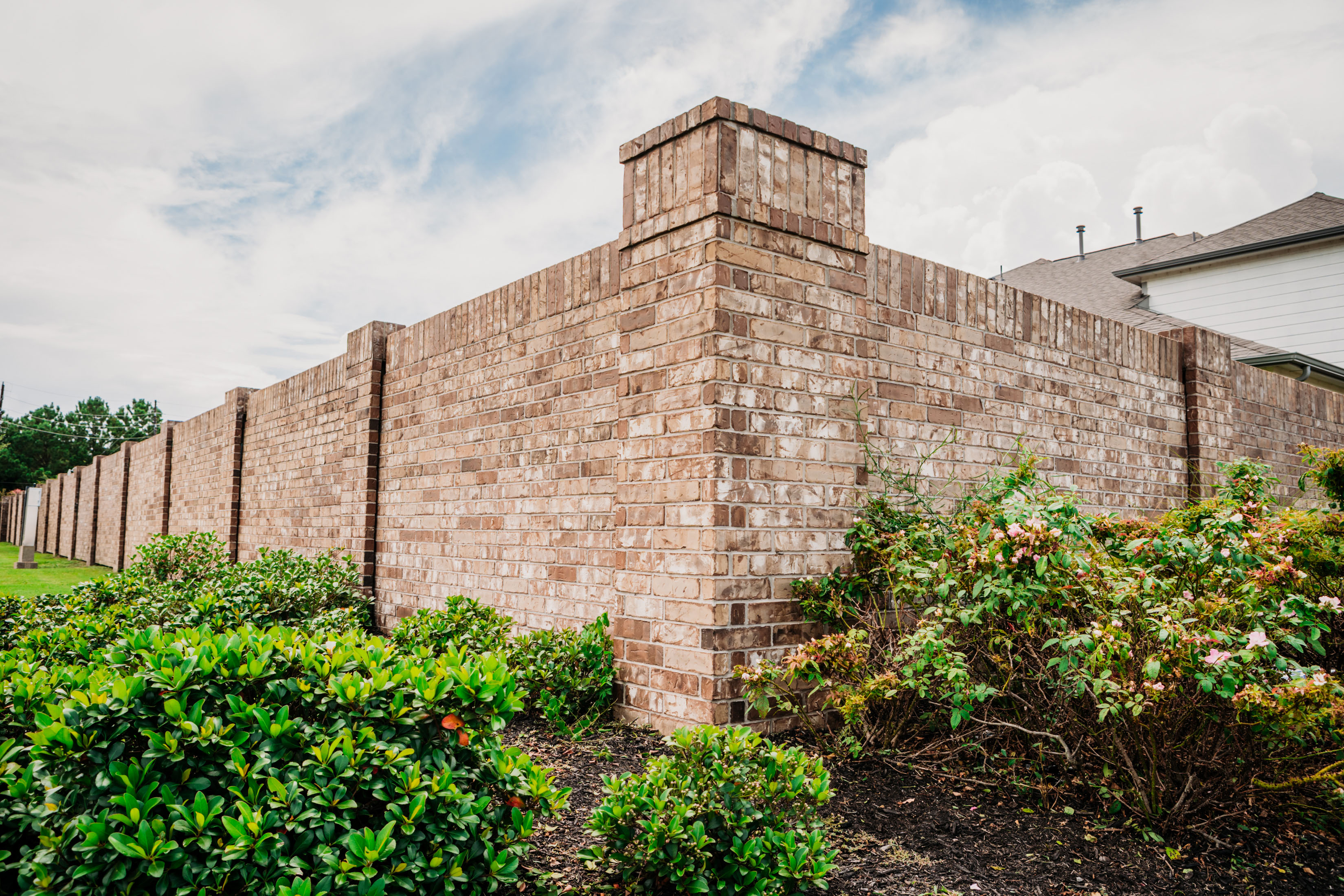 Brick Perimeter Wall in color complementing the Community Aesthetics