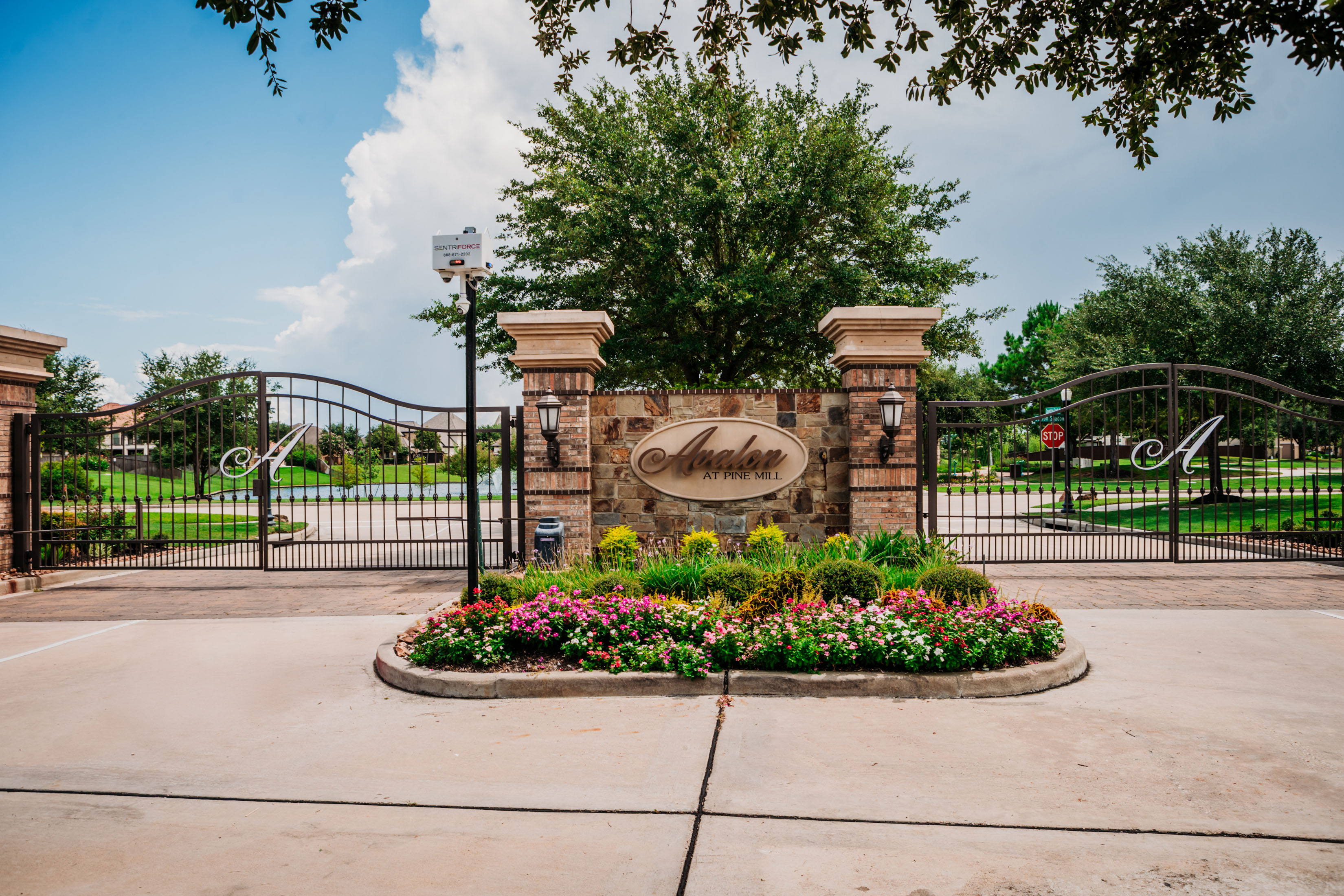 Iron Vehicular Entry Gate set in Decorative Masonry Wall for exclusive Gated Entry