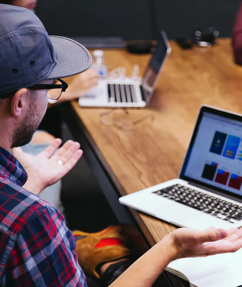 A man sitting in front of his computer participating in a virtual meeting 