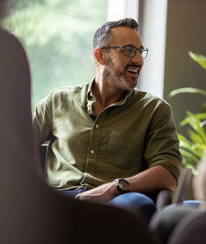 A man sitting in front of his computer participating in a virtual meeting 