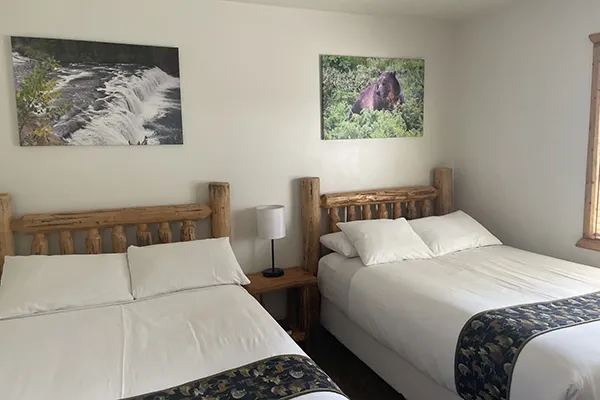 The Fuschl Nature guest room in the Arabella Jagdhof Resort am Fuschlsee showing a bed and two chairs