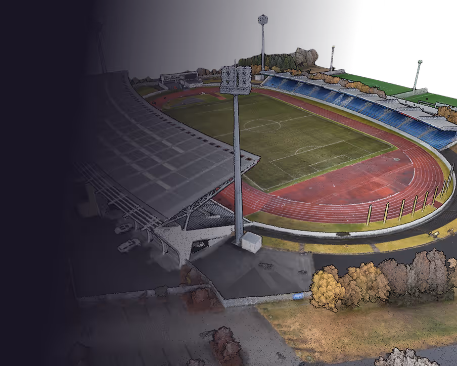 Aerial view of an empty outdoor stadium with a soccer field surrounded by a red running track and seating areas.