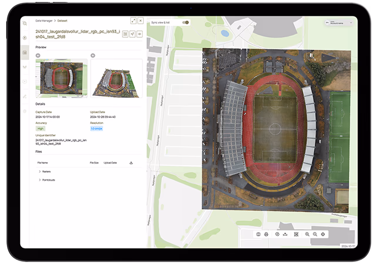 Tablet screen showing aerial map and detailed satellite images of a sports stadium with surrounding fields and parking areas.