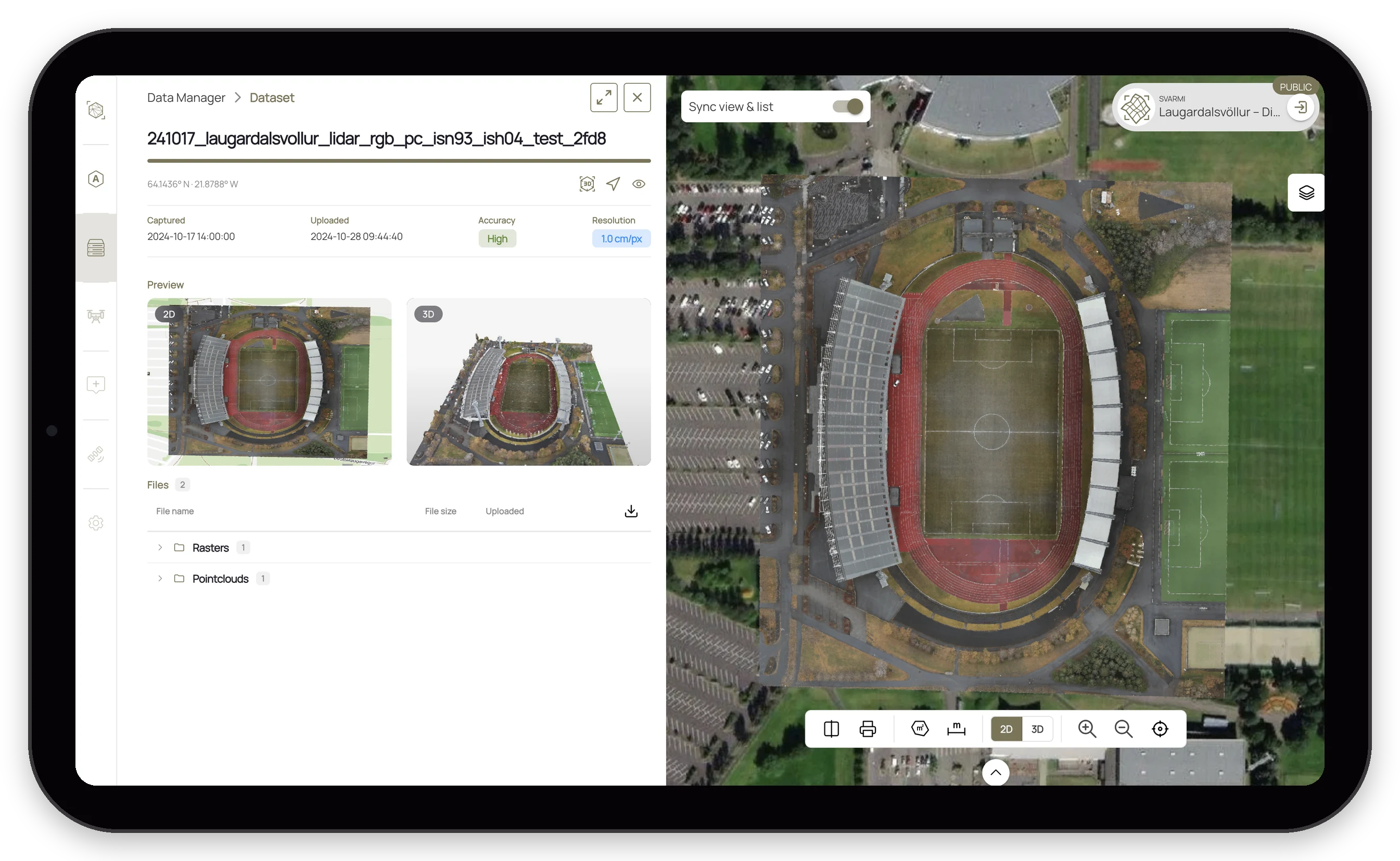 Tablet screen showing aerial map and detailed satellite images of a sports stadium with surrounding fields and parking areas.