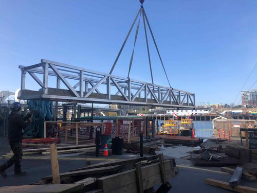 Steel beams being moved across dock