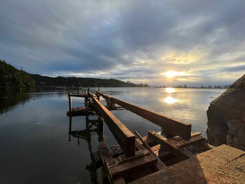 wooden beams building dock on lake