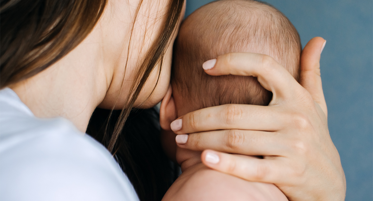Mother holding her new born baby closely