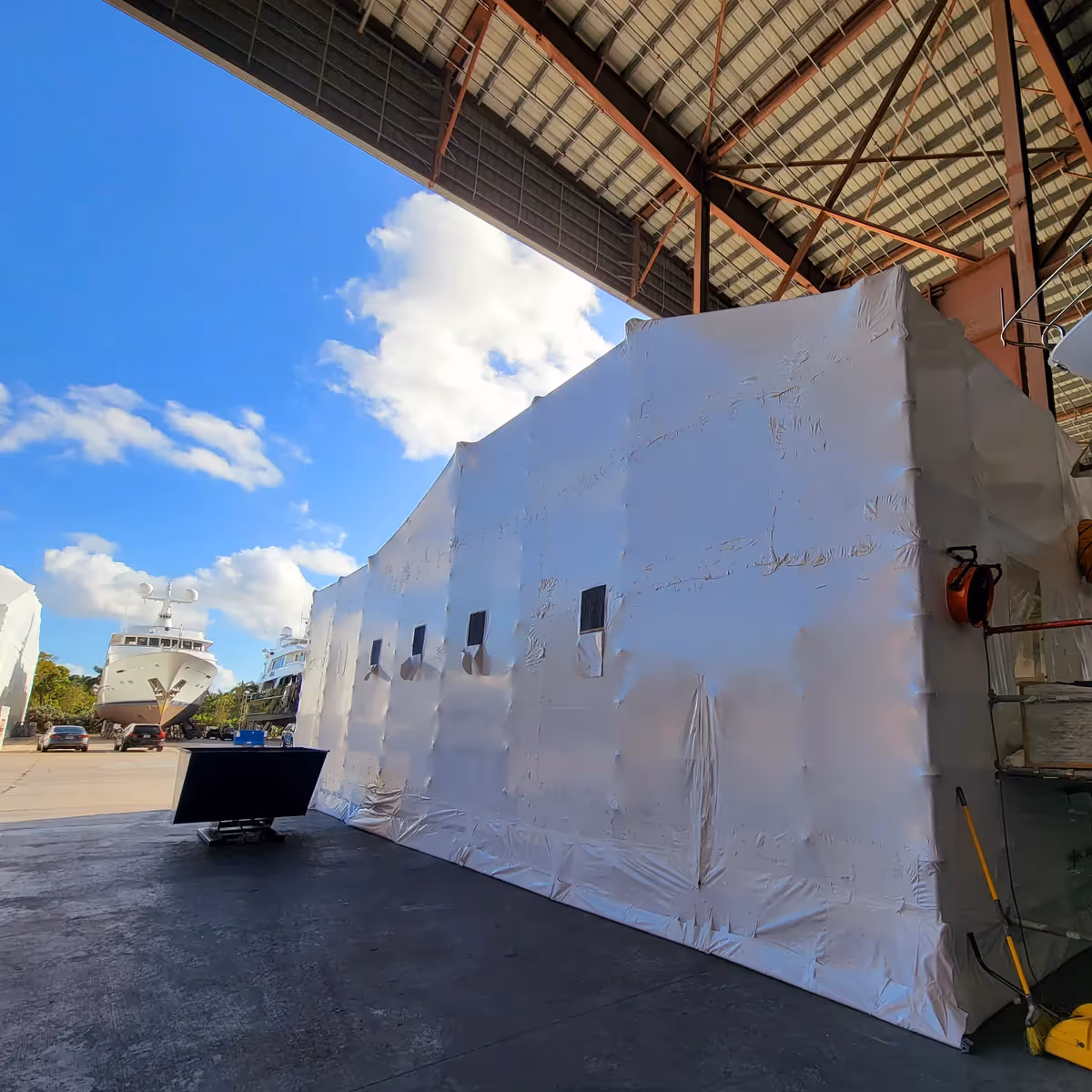 Yacht fully enclosed during repairs to ensure safety and quality access