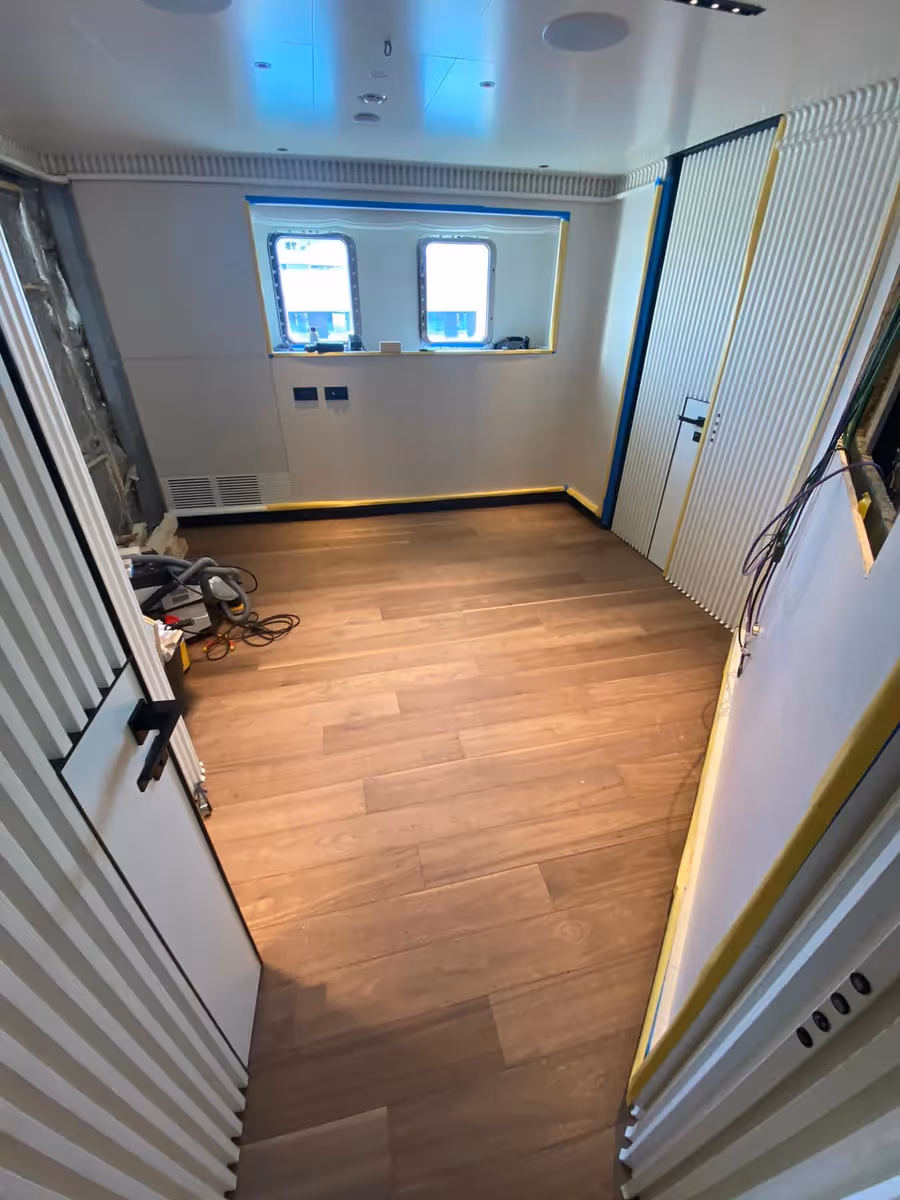 Refitted flooring creates a refreshed, seamless foundation for the new cabin