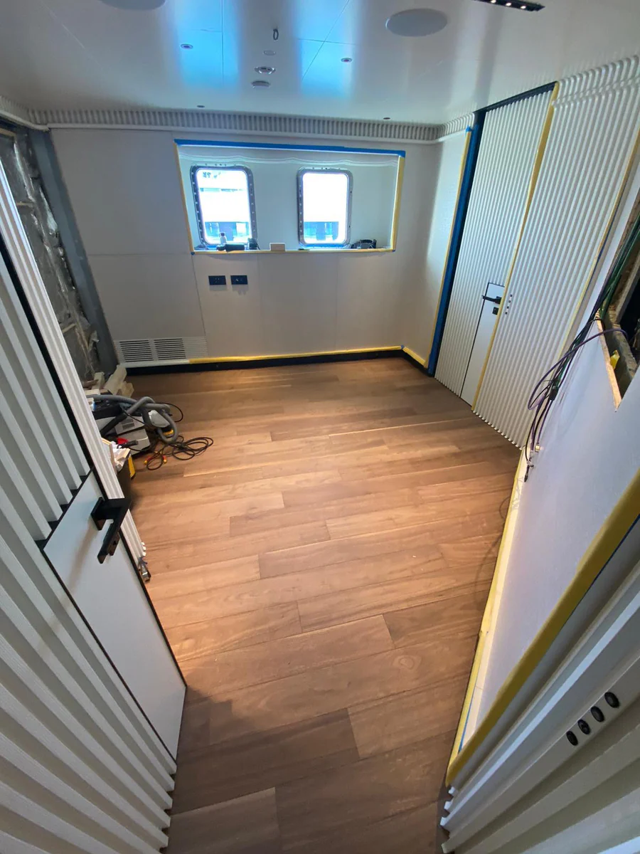 Refitted flooring creates a refreshed, seamless foundation for the new cabin