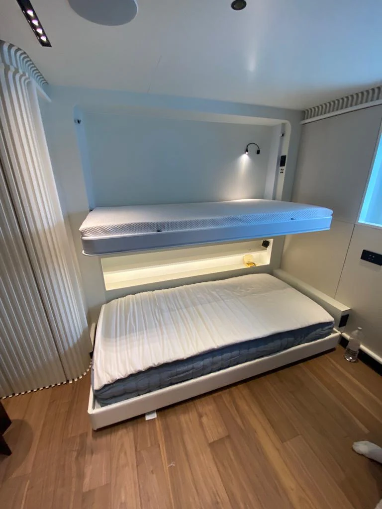 Innovative bunk setup with a fold-down upper bed maximises space and versatility