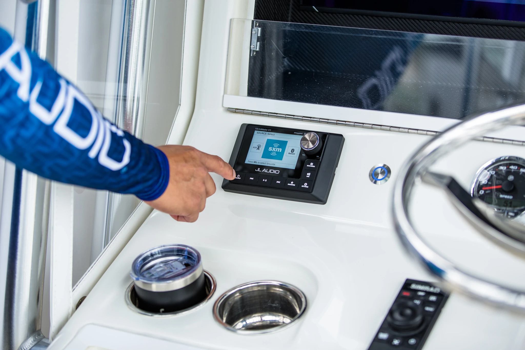 A person using a marine audio system on a boat