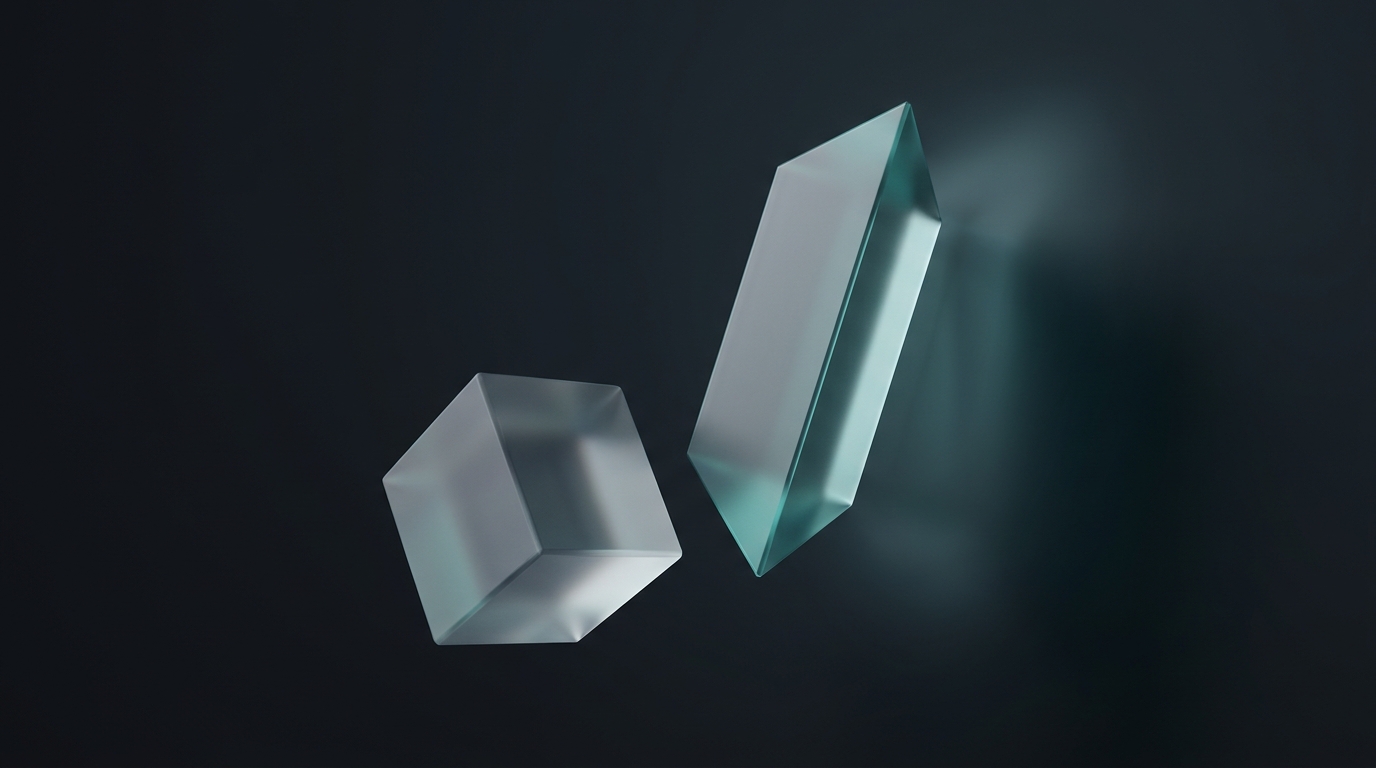 Two suspended geometric prisms side by side, one larger, lit by cool teal light against a deep slate background, soft directional shadows, frosted glass surfaces
