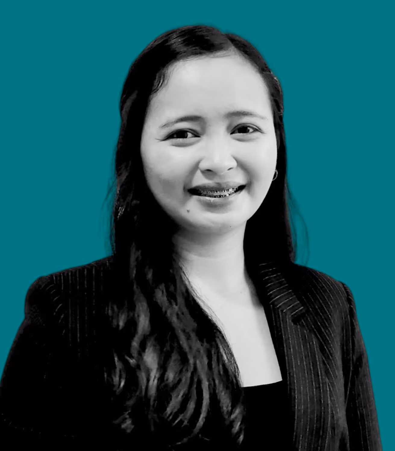 Woman with long dark hair and braces smiling, wearing a pinstripe blazer against a teal background.