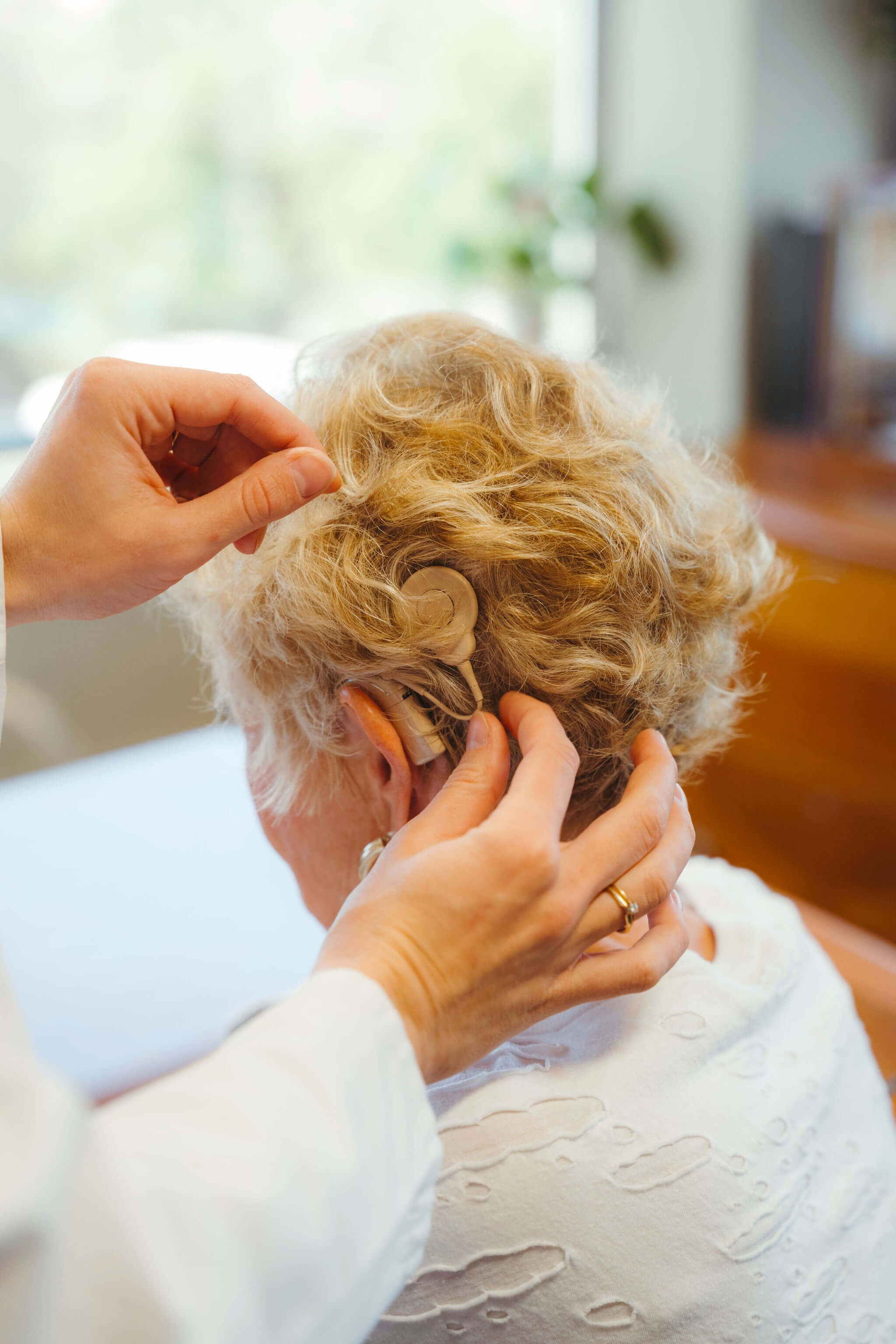 Cochlear implant processor worn behind the ear of a patient